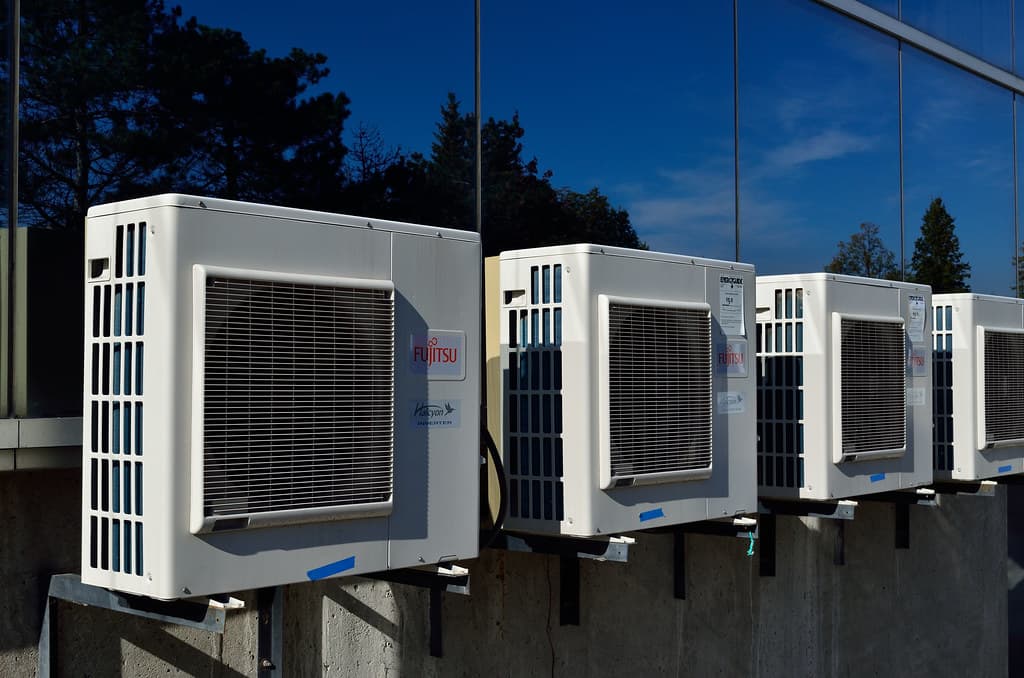 Row of wall-mounted air conditioner outdoor units